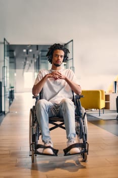 An African-American young entrepreneur in a wheelchair is surrounded by his business colleagues in a modern office setting, embodying diversity and collaboration in the workplace.