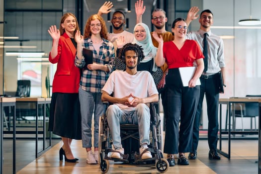 A diverse group of young business people walking a corridor in the glass-enclosed office of a modern startup, including a person in a wheelchair and a woman wearing a hijab.