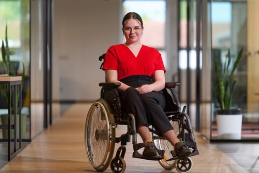 A modern young businesswoman in a wheelchair is surrounded by an inclusive workspace with glass-walled offices, embodying determination and innovation in the business world.