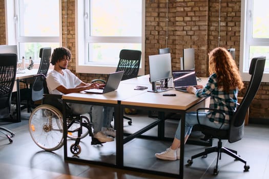 A diverse group of business professionals collaborates in a modern startup coworking center, utilizing a mix of paper-based and technological tools such as mobile phones and computers .