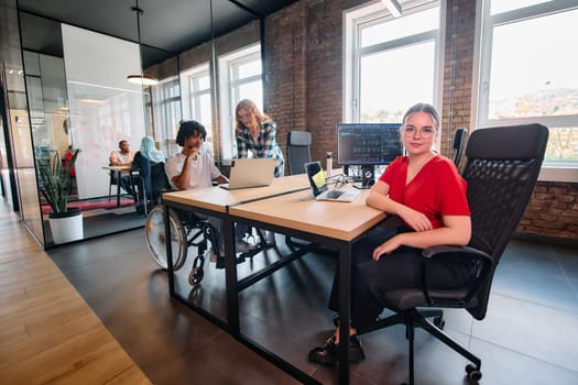 A diverse group of business professionals collaborates in a modern startup coworking center, utilizing a mix of paper-based and technological tools such as mobile phones and computers .