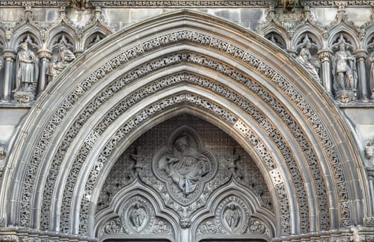 Edinburgh, Scotland - Jan 18, 2024 - Picturesque exterior view of Ornamental stonework arch above of The thistle chapel in St Giles' Cathedral (The High Kirk) entrance in Edinburgh. The most important place of worship in the Edinburgh, Space for text, Selective focus.