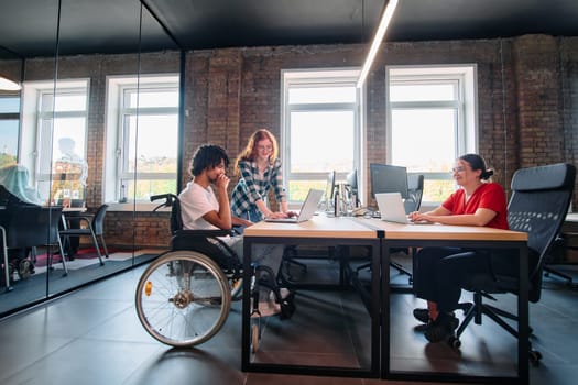 A diverse group of business professionals collaborates in a modern startup coworking center, utilizing a mix of paper-based and technological tools such as mobile phones and computers .