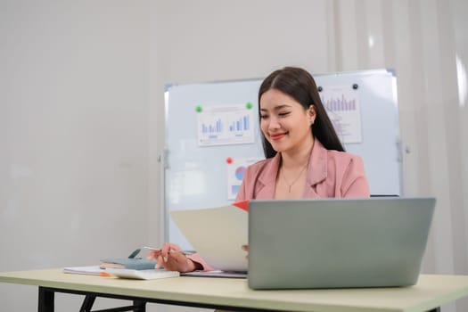 Beautiful business woman with determination Working on laptop in modern office.