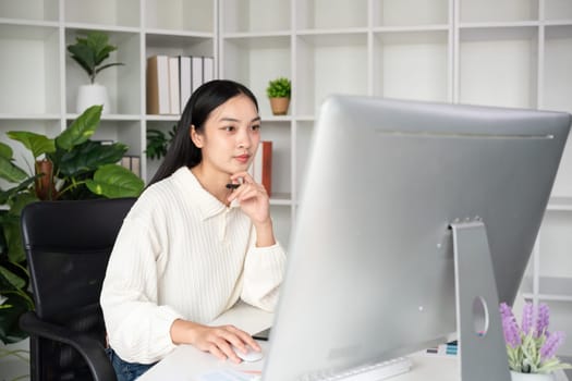 Beautiful business woman with determination Working on computer in home office.