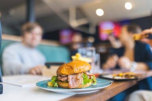 Big tasty burger in restaurant, close up