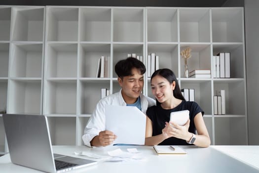 Happy young couple Checking Financial Documents And Calculating Budget At Home. paying taxes.