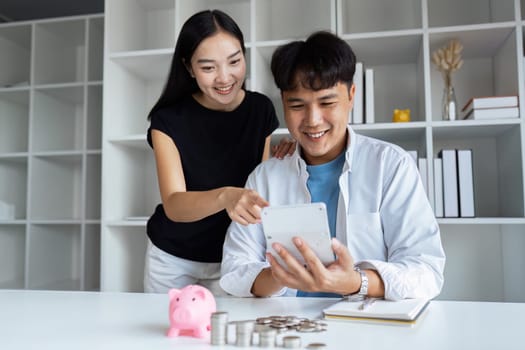 Happy young couple Checking Financial Documents And Calculating Budget At Home. paying taxes, saving money concept.