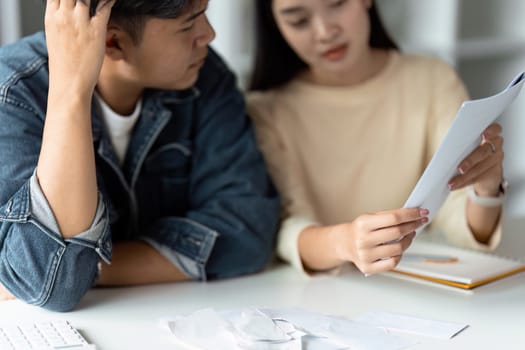 Happy young couple Checking Financial Documents And Calculating Budget At Home. paying taxes.