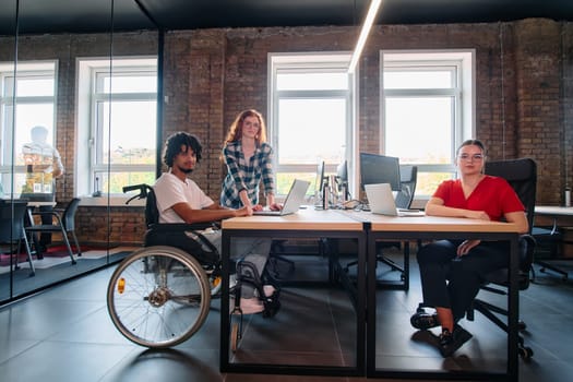 A diverse group of business professionals collaborates in a modern startup coworking center, utilizing a mix of paper-based and technological tools such as mobile phones and computers .