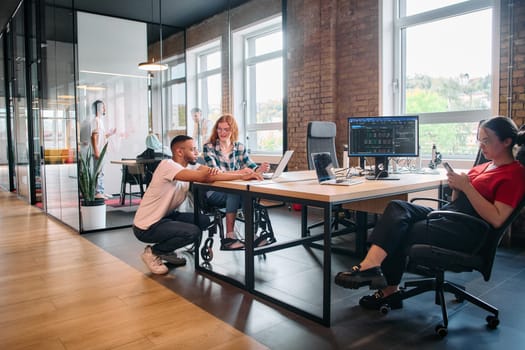 A diverse group of business professionals collaborates in a modern startup coworking center, utilizing a mix of paper-based and technological tools such as mobile phones and computers .