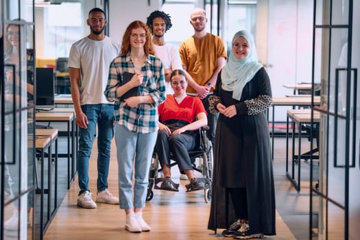 people walking a corridor in the glass-enclosed office of a modern startup, including a person in a wheelchair and a woman wearing a hijab.