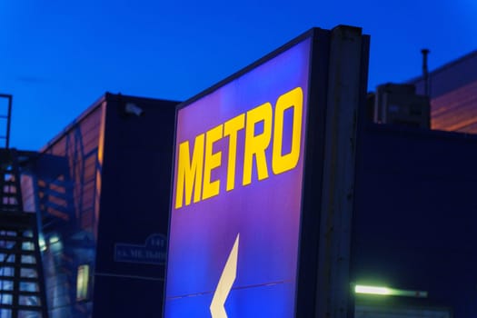 Tyumen, Russia-March 02, 2024: Metro logo close up Sign Against City Skyline