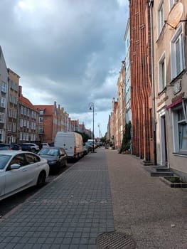 Gdansk, Poland, city center, historical street view with cars parked in the cloudy day. High quality photo