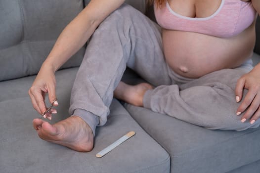 Pregnant woman trying to get herself a pedicure