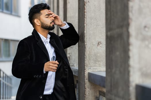 Unhappy sad Indian business man frustrated stress pensive feeling bad after company lost job unemployment problem financial crisis. Arabian Hindu freelancer guy stay at office business center building