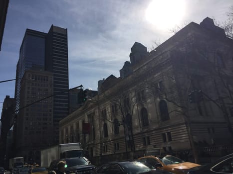 Busy new york city with many cars and taxies, van, buildings skyscraper in winter sunny day. High quality photo