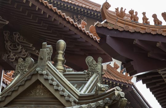 Bangkok, Thailand - Apr 11, 2024 - Golden gable roof architecture inside of Taiwanese temple at Fo Guang Shan Thaihua Temple. Taiwanese temple style, The Institute of Buddhism, Space for text, Selective focus.