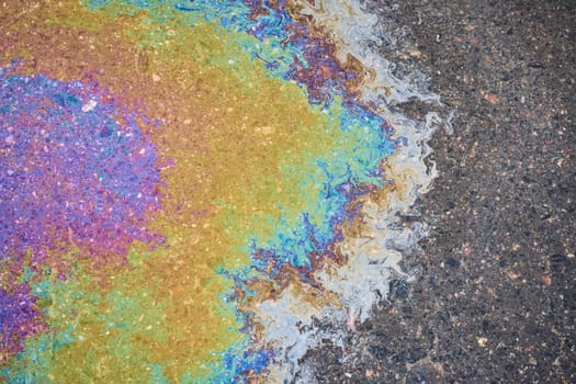 Oil Spill on Asphalt, Colorful Gasoline Fuel Stains on Asphalt Road as Texture or Background