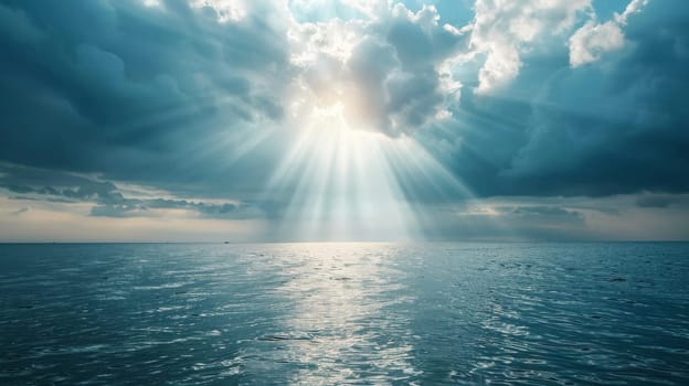The sun is shining through the clouds over the ocean. The sky is blue and the water is calm