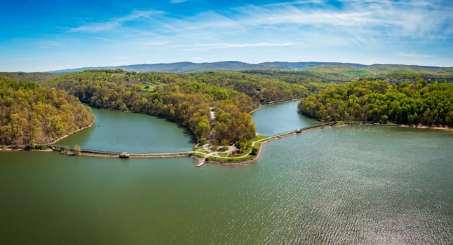 Aerial view as sun casts warm light on the park at Cheat Lake near Morgantown West Virginia on a beautiful calm spring morning