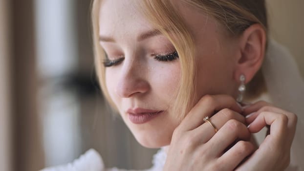 The bride corrects her earring