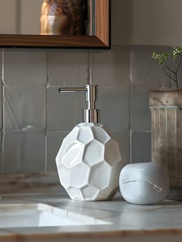 A sleek white soap dispenser complements the light wood counter, enhancing the interior design. The soap dish is placed next to a glass plant and a picture frame, creating a harmonious look