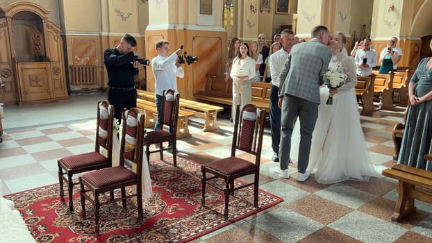 A father takes his daughter to a wedding in a Catholic church