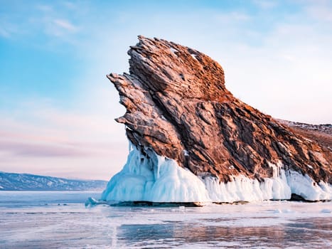 Ogoy island on winter Baikal lake. Winter scenery of Dragon Tail Rock on Ogoy island during sunrise at Lake Baikal.