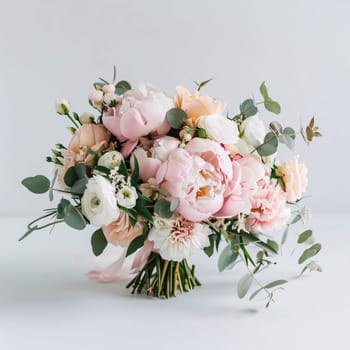 Bouquet of white and pink flowers with green leaves on a light background. Flowering flowers, a symbol of spring, new life. A joyful time of nature waking up to life.