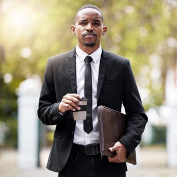 Coffee, documents and portrait of lawyer black man in park on morning commute to court for trial. Law, legal and serious with confident attorney walking outdoor in garden of city for case or hearing.