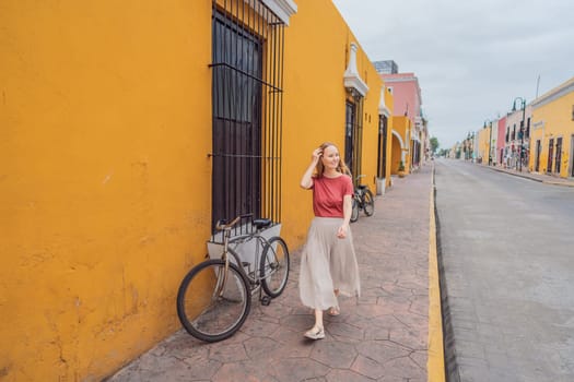 Woman tourist explores the vibrant streets of Valladolid, Mexico, immersing herself in the rich culture and colorful architecture of this charming colonial town.