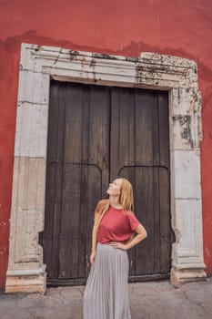 Woman tourist explores the vibrant streets of Valladolid, Mexico, immersing herself in the rich culture and colorful architecture of this charming colonial town.