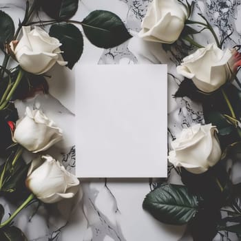 White blank card on a marble background around white roses flowers. Places on their own content. Flowering flowers, a symbol of spring, new life. A joyful time of nature waking up to life.
