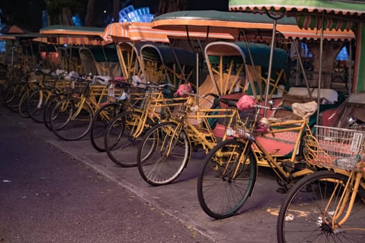 Empty rickshaws on night street of Macau