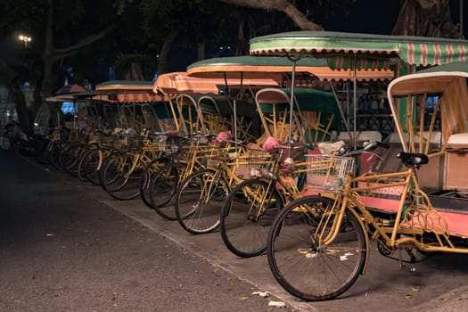 Empty rickshaws on night street of Macau