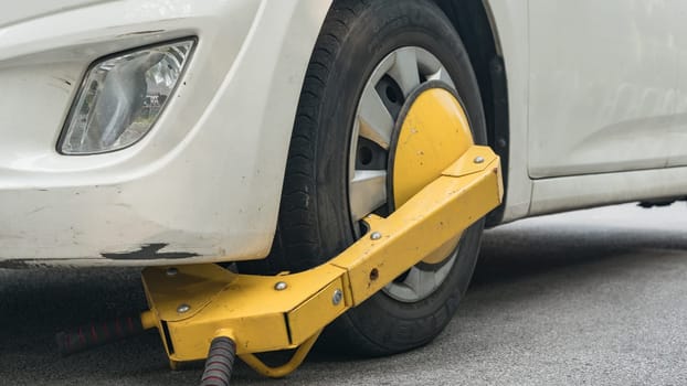 Locked wheel of a car parked in an improper place