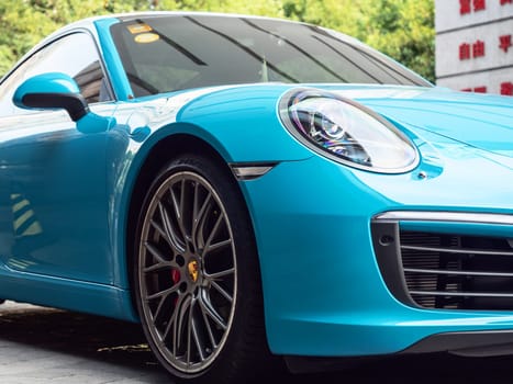 Close-up photo of blue Porsche at motorshow