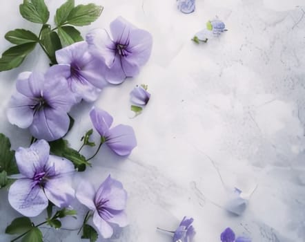Purple flowers lying on a marble background. Flowering flowers, a symbol of spring, new life. A joyful time of nature awakening to life.