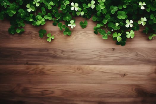 Top view of scattered four-leaf green clovers on wooden background, banner space for your own content. Green four-leaf clover symbol of St. Patrick's Day. A joyous time of celebration in the green color.