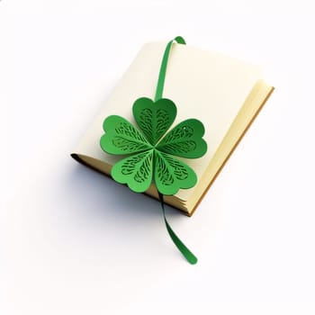 Book and froth of green five-leaf clover, white background. Green four-leaf clover symbol of St. Patrick's Day. Happy time of celebration in green color.