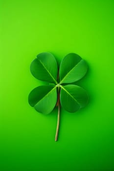Torn four-leaf clover on isolated light green background. Green four-leaf clover symbol of St. Patrick's Day. Happy time of celebration in green color.