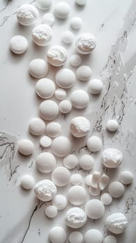 A bunch of white pills on a marble counter top