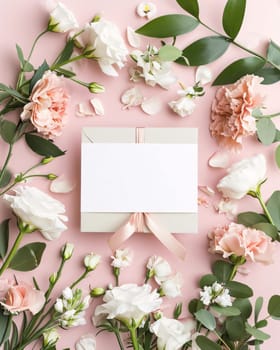 White blank card with space for your own content. Around the decoration with fresh white flowers with green leaves. Valentine's Day as a day symbol of affection and love. A time of falling in love and love.