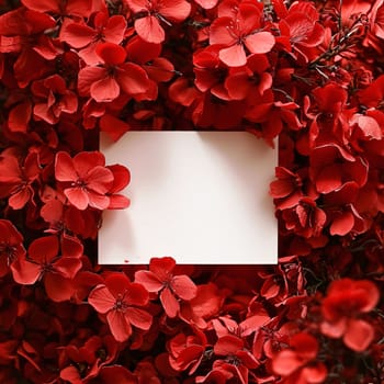 White blank card with space for your own content. Around red flowers, flower petals. Valentine's Day as a day symbol of affection and love. A time of falling in love and love.