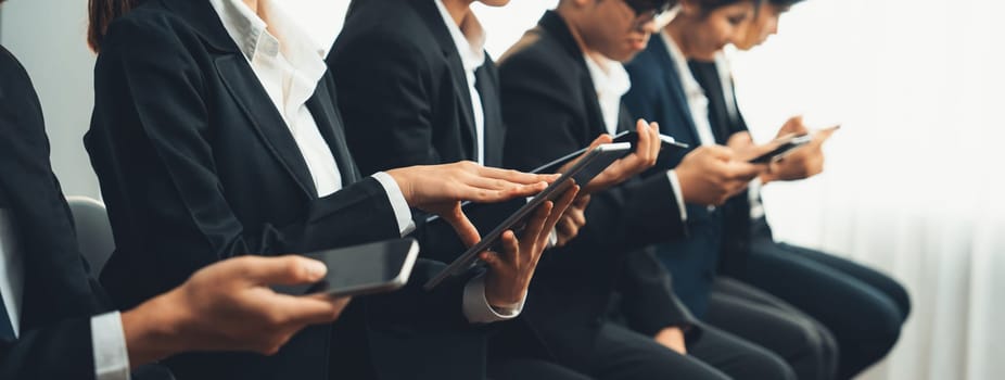 Group of interviewee candidate in formal suit line up for interview sitting on the chair. Job opportunity recruitment for HR agency and vacancy concept. Shrewd