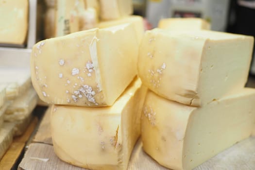 many type of cheeses on shop window.