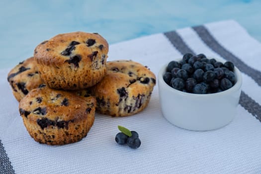 Homemade baked blueberry muffins with fresh blackberries. Tasty pastry sweet cupcake dessert. Berry pie Healthy vegan cupcakes with organic berries. Gluten free healthcare recipe from alternative flour