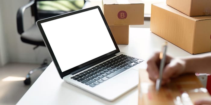 Mockup of white empty display laptop with box. Concept of online business.