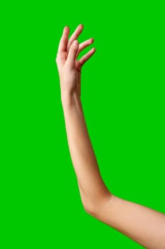 A human hand stretches upward into the air against a solid green background. The fingers are outstretched and reaching as if trying to grasp something above. The hand is the focal point, contrasting against the vibrant green backdrop.